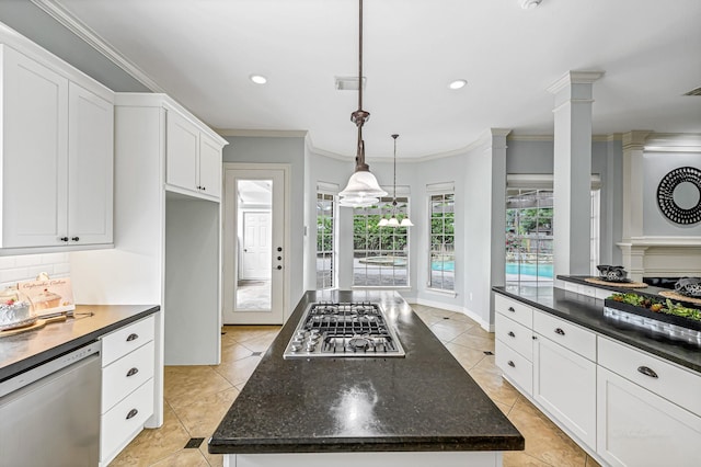 4602 Gladesdale Park Ln, Katy, TX 77450 - kitchen with stainless steel appliances, ornamental molding, white cabinets, ornate columns, and recessed lighting