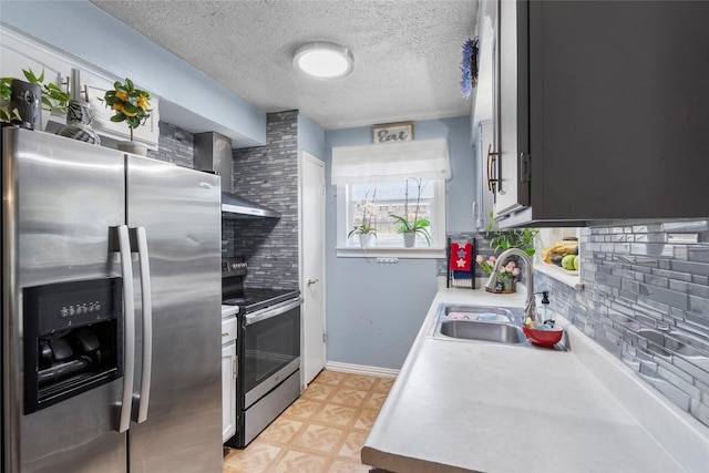 10507 Kirkhill Dr, Houston, TX 77089 - kitchen featuring appliances with stainless steel finishes, backsplash, light countertops, a textured ceiling, and wall chimney exhaust hood