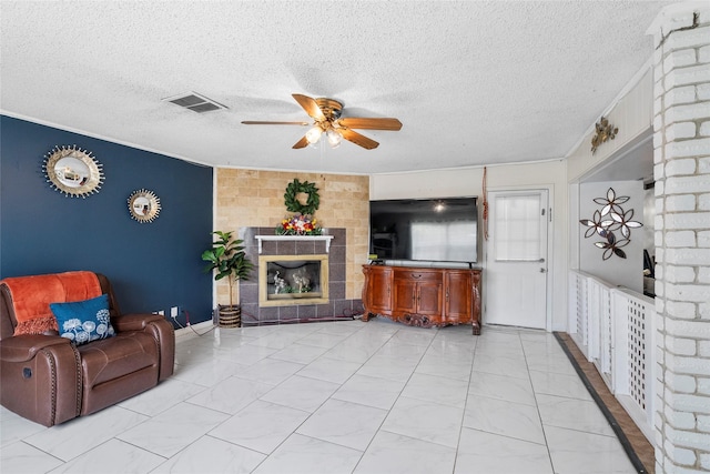10507 Kirkhill Dr, Houston, TX 77089 - living room with ceiling fan, light marble finish flooring, a textured ceiling, a fireplace, and crown molding