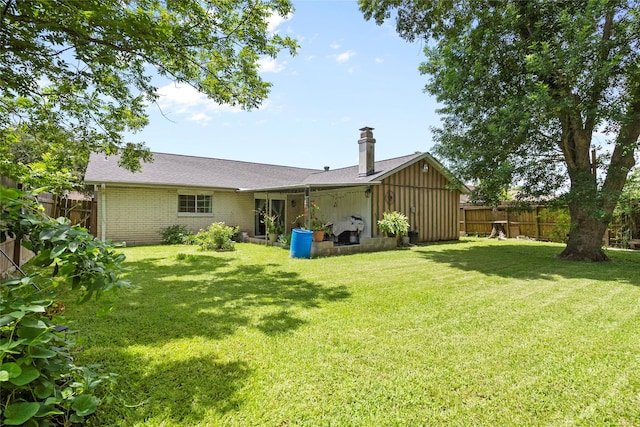 10507 Kirkhill Dr, Houston, TX 77089 - back of property with a fenced backyard, brick siding, and a chimney