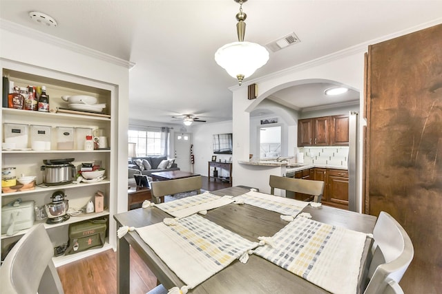 1311 Antoine Dr Unit 110, Houston, TX 77055 - dining space featuring wood finished floors, a ceiling fan, arched walkways, and ornamental molding