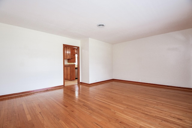 1215 W 31st St, Houston, TX 77018 - spare room featuring baseboards and light wood-style floors
