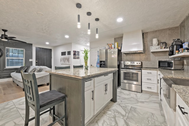 826 Rosewick St, Houston, TX 77015 - kitchen featuring appliances with stainless steel finishes, custom range hood, light marble finish flooring, open shelves, and a textured ceiling