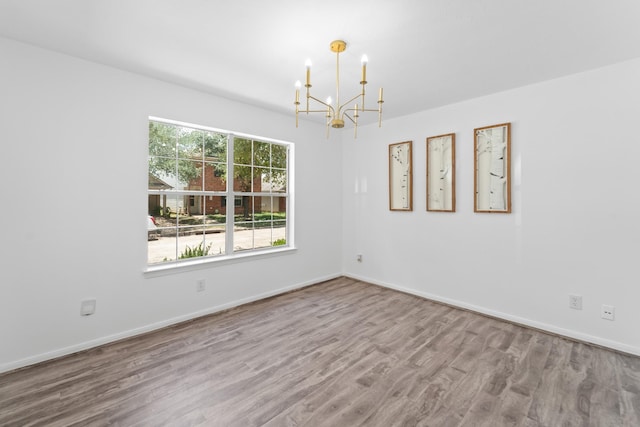 6310 Mountain Pines Ln, Katy, TX 77449 - unfurnished room with a chandelier and wood finished floors