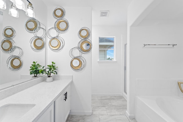 6310 Mountain Pines Ln, Katy, TX 77449 - bathroom featuring marble finish floors, vanity, a bath, and a shower with shower door