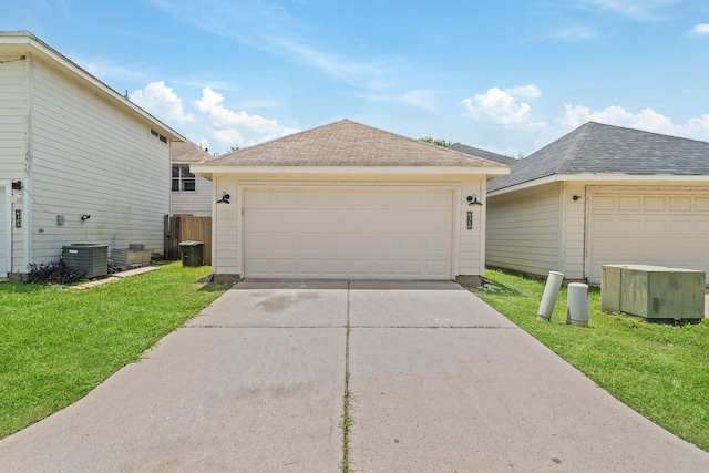 6310 Mountain Pines Ln, Katy, TX 77449 - view of front of property featuring a front lawn, a detached garage, and a shingled roof