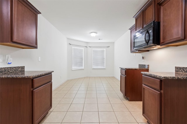 6615 Lost Pines Bnd, Houston, TX 77049 - kitchen featuring black microwave, light tile patterned floors, and dark stone countertops