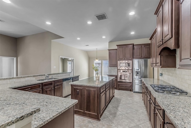2206 Chelsea Creek Ln, Spring, TX 77386 - kitchen with appliances with stainless steel finishes, tasteful backsplash, a center island, and recessed lighting