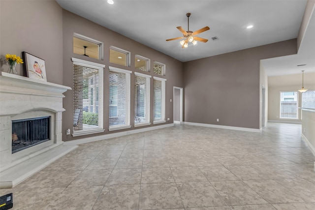 2206 Chelsea Creek Ln, Spring, TX 77386 - unfurnished living room with a ceiling fan, tile patterned flooring, a high end fireplace, and recessed lighting