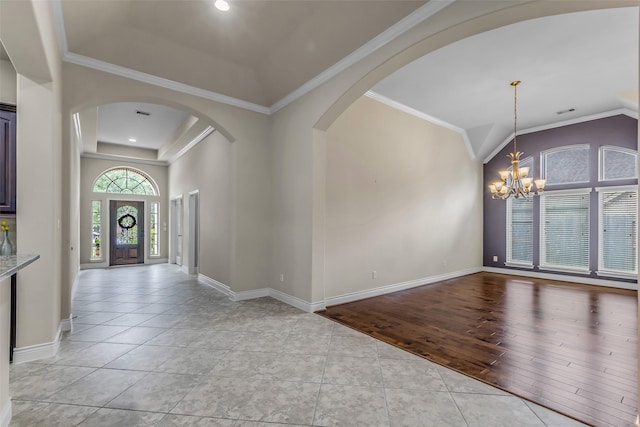 2206 Chelsea Creek Ln, Spring, TX 77386 - entryway with arched walkways, a chandelier, vaulted ceiling, light tile patterned floors, and crown molding