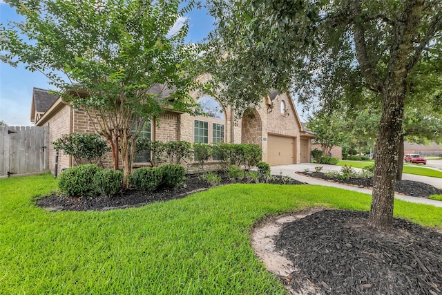 2206 Chelsea Creek Ln, Spring, TX 77386 - obstructed view of property featuring concrete driveway, brick siding, a garage, and stone siding