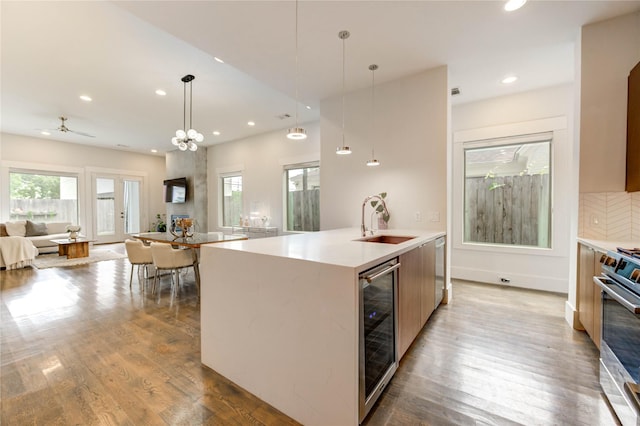 1919 Rosewood St, Houston, TX 77004 - kitchen with modern cabinets, open floor plan, beverage cooler, stove, and wood finished floors