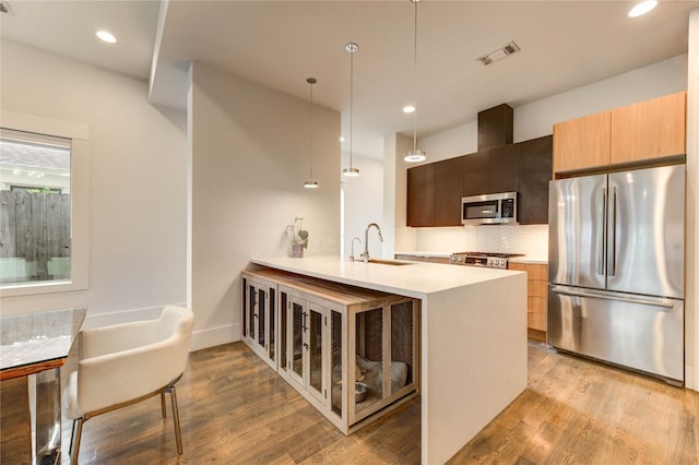 1919 Rosewood St, Houston, TX 77004 - kitchen with stainless steel appliances, light countertops, light wood-style flooring, modern cabinets, and backsplash
