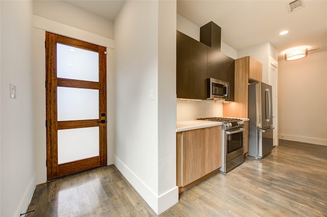 1919 Rosewood St, Houston, TX 77004 - kitchen featuring stainless steel appliances, modern cabinets, light wood-style floors, light countertops, and recessed lighting