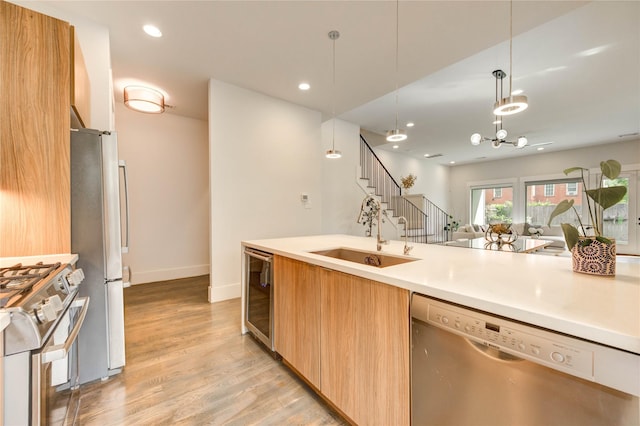 1919 Rosewood St, Houston, TX 77004 - kitchen featuring appliances with stainless steel finishes, beverage cooler, modern cabinets, open floor plan, and light wood-style floors