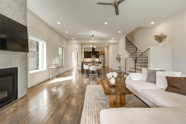 1919 Rosewood St, Houston, TX 77004 - living room with wood finished floors, stairway, a glass covered fireplace, a ceiling fan, and recessed lighting