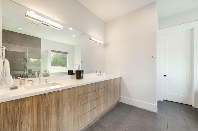 1919 Rosewood St, Houston, TX 77004 - bathroom with double vanity, a shower stall, tile patterned floors, and recessed lighting