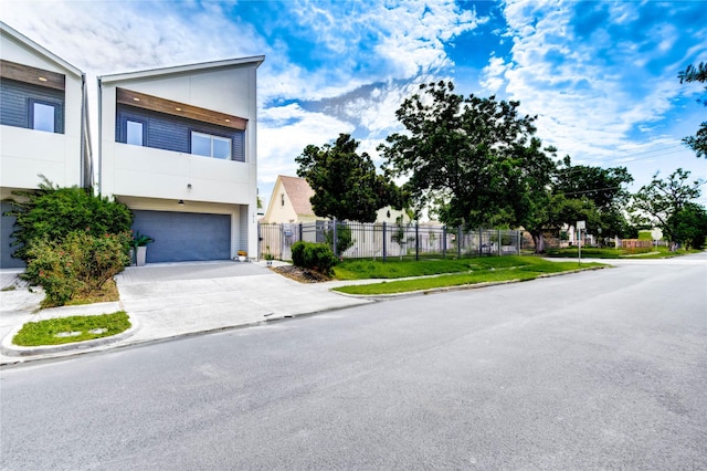 1919 Rosewood St, Houston, TX 77004 - view of front facade with a garage, driveway, stucco siding, and a residential view