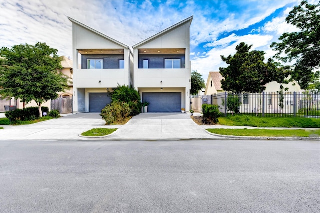 1919 Rosewood St, Houston, TX 77004 - view of front of property featuring a garage, concrete driveway, stucco siding, and a balcony