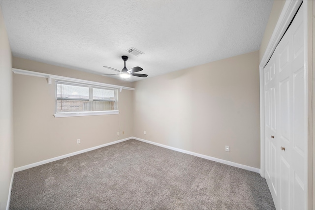 21627 Cimarron Pkwy, Katy, TX 77450 - unfurnished bedroom featuring a closet, carpet, a textured ceiling, and a ceiling fan