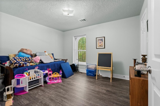 2318 Pleasant Crk, Houston, TX 77345 - bedroom with wood finished floors and a textured ceiling