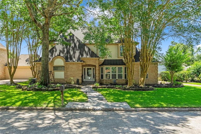 2318 Pleasant Crk, Houston, TX 77345 - view of front of property featuring a front lawn, roof with shingles, brick siding, and stucco siding