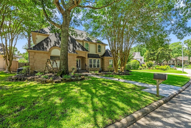 2318 Pleasant Crk, Houston, TX 77345 - view of front of house with roof with shingles, stucco siding, and brick siding
