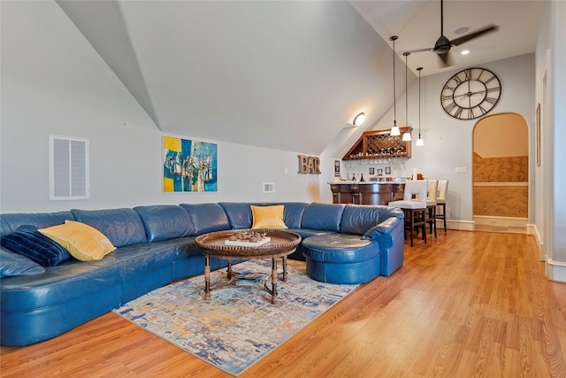 2750 Fm 563, Anahuac, TX 77514 - living area featuring vaulted ceiling, a bar, a ceiling fan, light wood-style floors, and recessed lighting