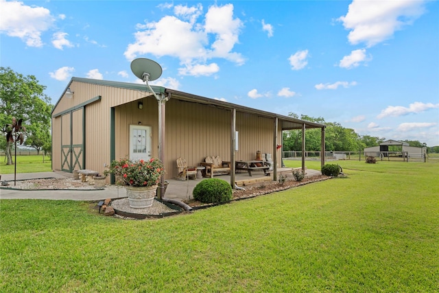 2750 Fm 563, Anahuac, TX 77514 - back of house featuring a patio, an outbuilding, and a garage