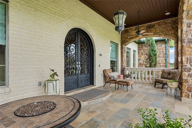 2750 Fm 563, Anahuac, TX 77514 - doorway to property with covered porch, brick siding, and ceiling fan