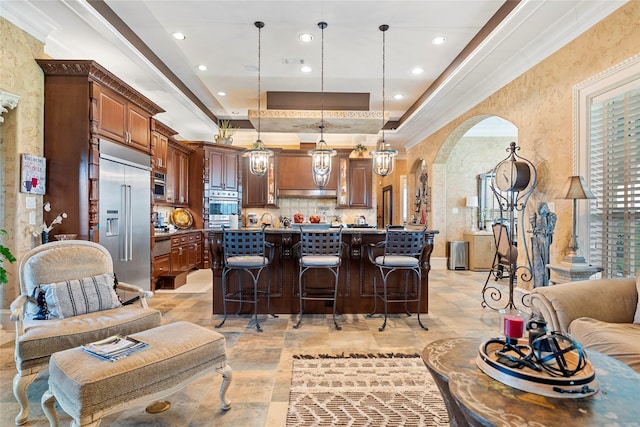 2750 Fm 563, Anahuac, TX 77514 - kitchen featuring stainless steel appliances, a kitchen bar, decorative backsplash, recessed lighting, and a raised ceiling