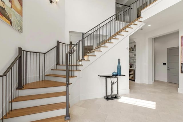 7526 Janak Dr, Houston, TX 77055 - staircase featuring a towering ceiling and baseboards
