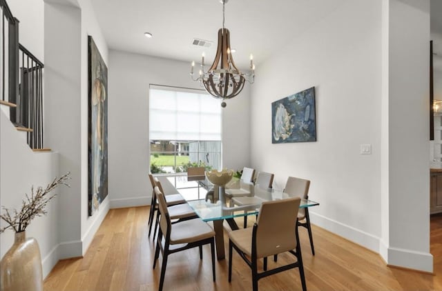 7526 Janak Dr, Houston, TX 77055 - dining area featuring a chandelier, stairway, light wood finished floors, and recessed lighting