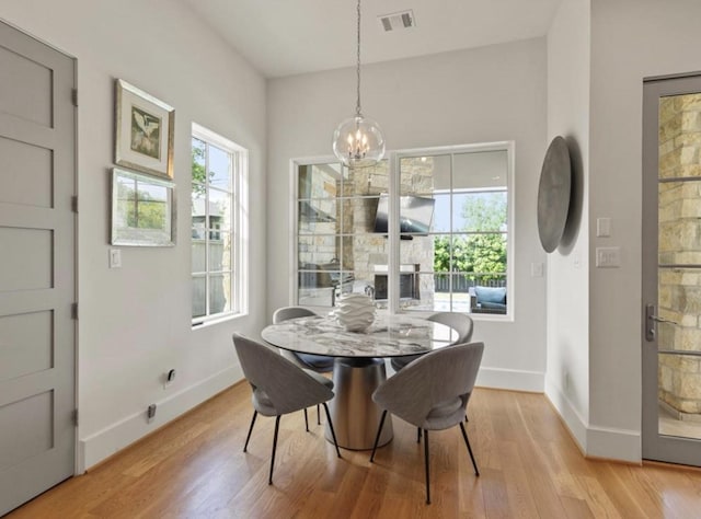 7526 Janak Dr, Houston, TX 77055 - dining area featuring a chandelier and light wood-style flooring