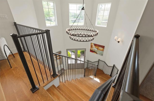 7526 Janak Dr, Houston, TX 77055 - staircase with wood finished floors, a chandelier, and a high ceiling