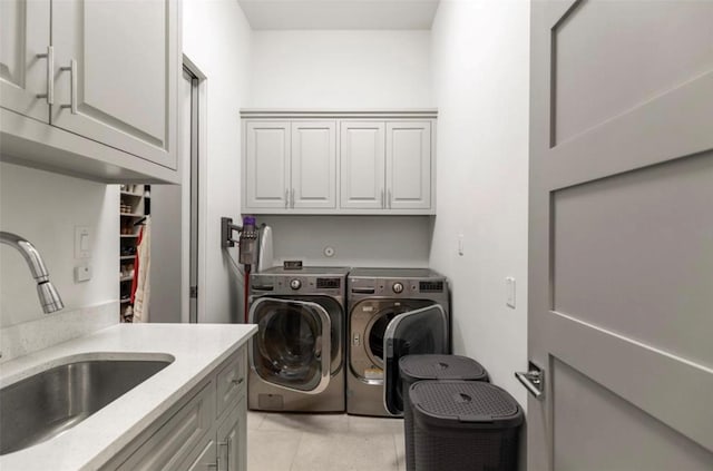 7526 Janak Dr, Houston, TX 77055 - laundry room featuring cabinet space, separate washer and dryer, and light tile patterned floors