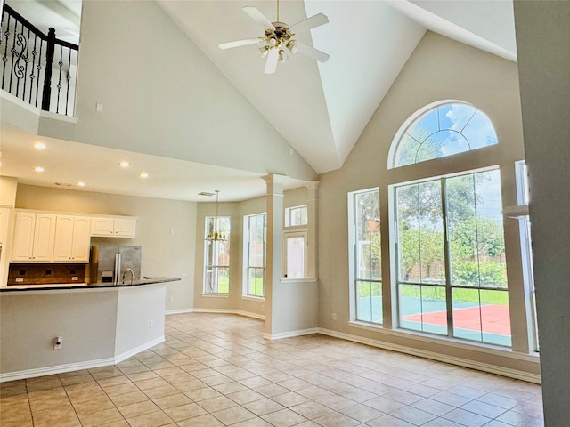 5403 Emerald Pointe Ln, Sugar Land, TX 77479 - unfurnished living room with light tile patterned floors, high vaulted ceiling, ceiling fan, recessed lighting, and a chandelier