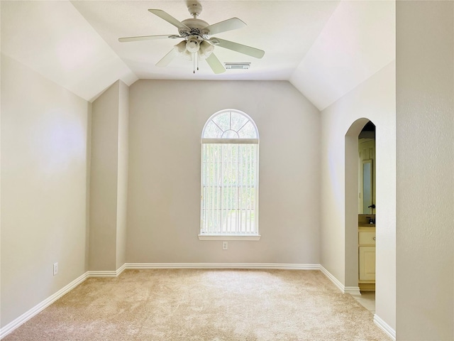 5403 Emerald Pointe Ln, Sugar Land, TX 77479 - unfurnished room featuring arched walkways, light carpet, lofted ceiling, and ceiling fan