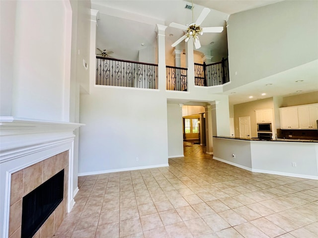 5403 Emerald Pointe Ln, Sugar Land, TX 77479 - unfurnished living room with ceiling fan, a tile fireplace, high vaulted ceiling, and light tile patterned flooring