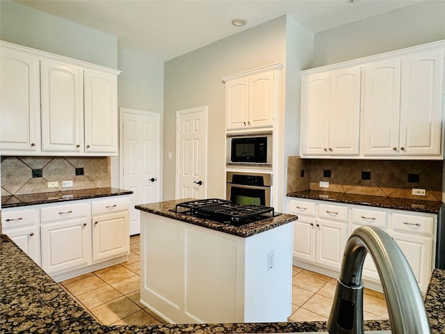 5403 Emerald Pointe Ln, Sugar Land, TX 77479 - kitchen featuring black appliances, dark stone counters, light tile patterned floors, decorative backsplash, and white cabinets
