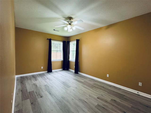 5403 Emerald Pointe Ln, Sugar Land, TX 77479 - spare room with a ceiling fan, wood finished floors, and a textured ceiling