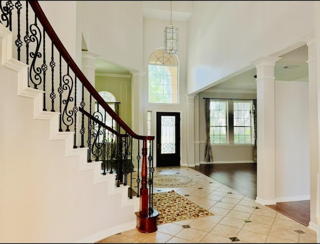 5403 Emerald Pointe Ln, Sugar Land, TX 77479 - entrance foyer featuring a towering ceiling, decorative columns, tile patterned flooring, and stairs