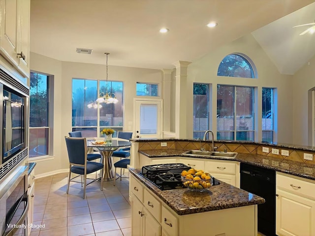 5403 Emerald Pointe Ln, Sugar Land, TX 77479 - kitchen with black appliances, light tile patterned floors, dark stone countertops, decorative backsplash, and recessed lighting