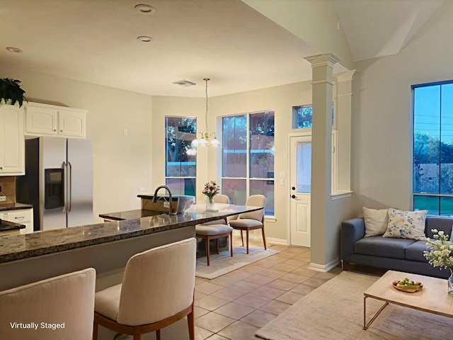 5403 Emerald Pointe Ln, Sugar Land, TX 77479 - living room featuring a chandelier, light tile patterned floors, and ornate columns