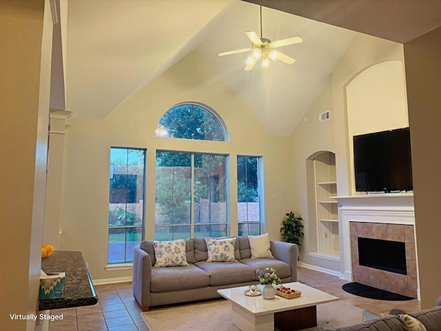 5403 Emerald Pointe Ln, Sugar Land, TX 77479 - living room with light tile patterned flooring, high vaulted ceiling, healthy amount of natural light, built in features, and a ceiling fan