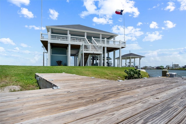 1301 Lagoon Dr, Crystal Beach, TX 77650 - back of property featuring a shingled roof, stairs, a lawn, and a deck with water view