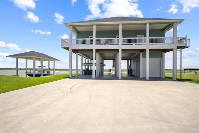 1301 Lagoon Dr, Crystal Beach, TX 77650 - coastal home with a carport, a garage, concrete driveway, and a water view