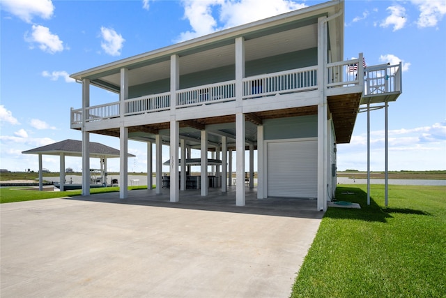 1301 Lagoon Dr, Crystal Beach, TX 77650 - coastal inspired home with a carport, concrete driveway, and a front lawn