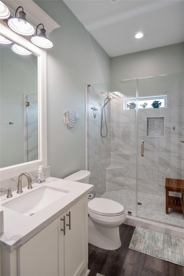 1301 Lagoon Dr, Crystal Beach, TX 77650 - full bathroom featuring vanity, a stall shower, wood finished floors, and recessed lighting