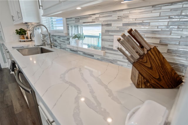 1301 Lagoon Dr, Crystal Beach, TX 77650 - kitchen with backsplash, white cabinetry, light stone counters, dark wood-style floors, and stainless steel dishwasher